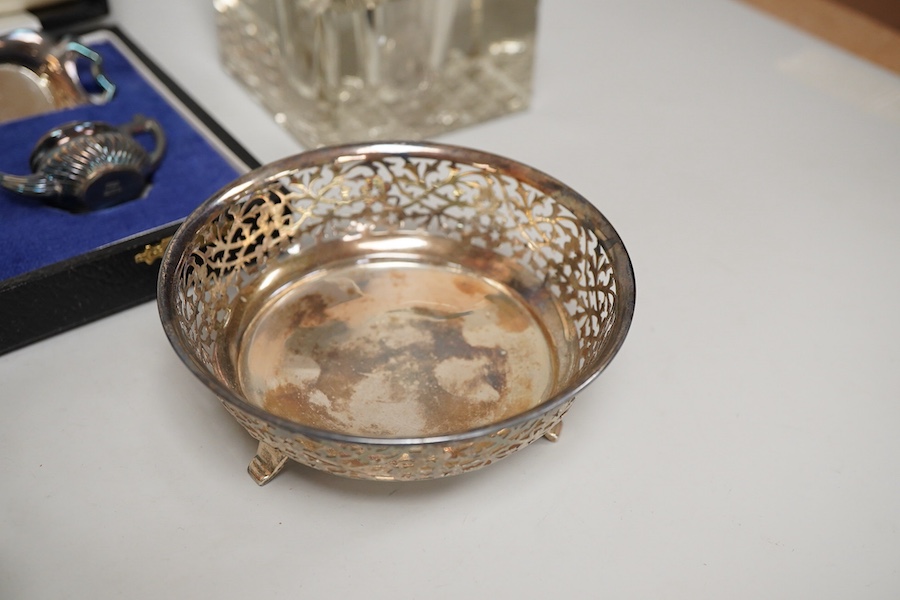 Small silver including a pair of George V pierced silver bonbon dishes, Birmingham, 1915, diameter 97mm, an Edwardian silver mounted glass inkwell, a cased modern silver miniature four piece tea set and tray and a German